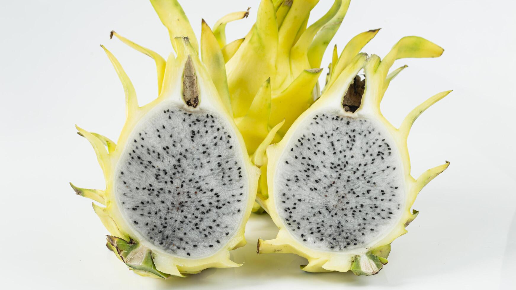 a dragon fruit is cut in half photo