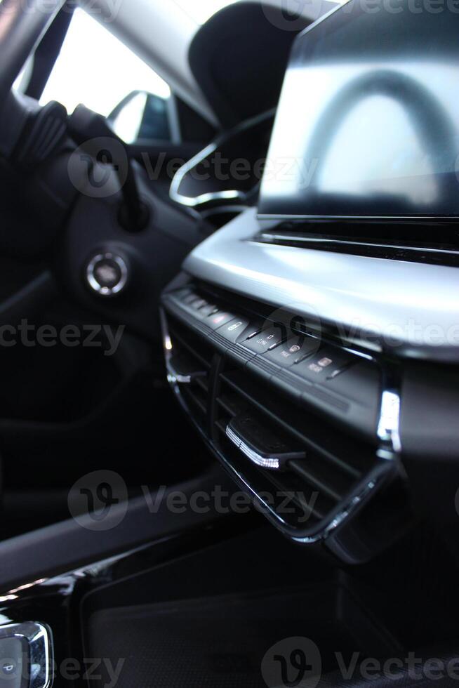 Closeup Side View Of Menu Buttons And Touch Screen Display In The Middle Of Central Panel In Modern Car photo