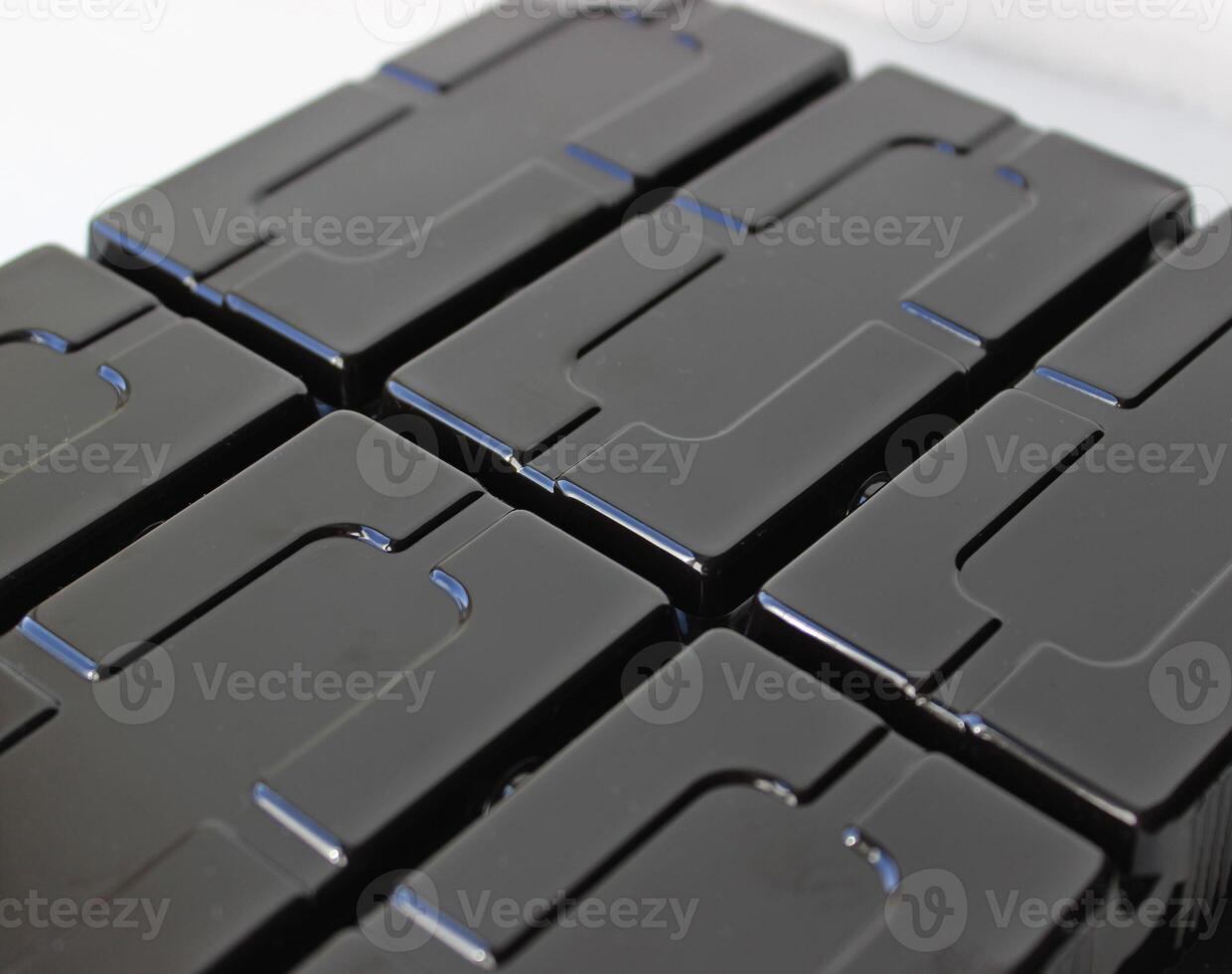 Rectangular Slots On A Black Glossy Plastic Panel photo