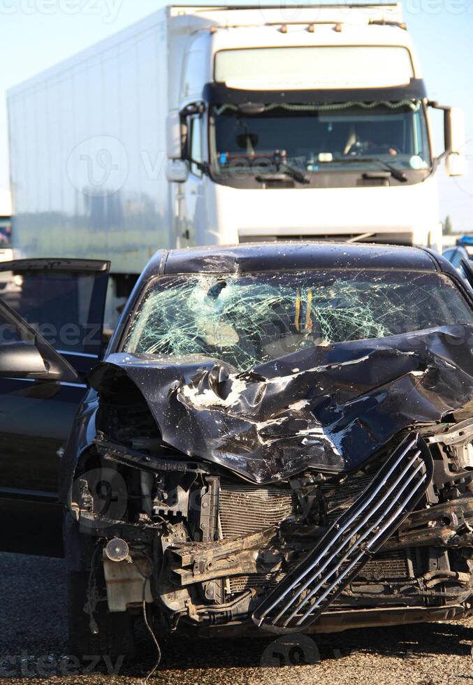 Consequences of a high-speed collision between a car and a truck on the highway photo