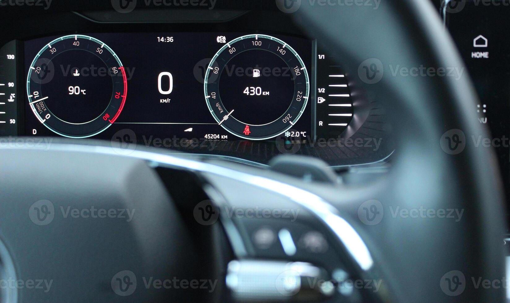 Engine operating temperature and remaining mileage before refueling at the instrument cluster on LED car dashboard photo