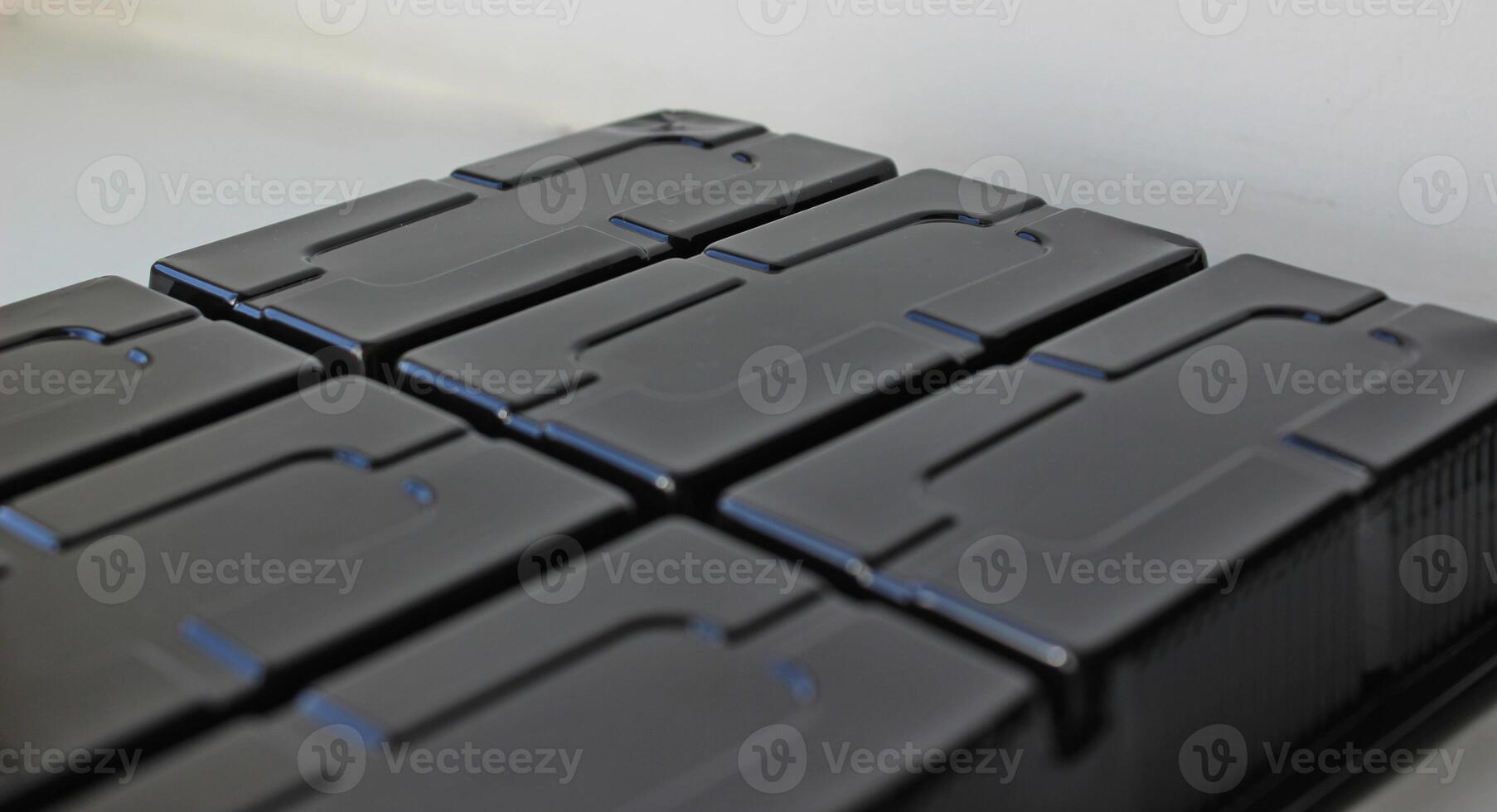 Abstract background of black plastic panel with rectangular slots photo