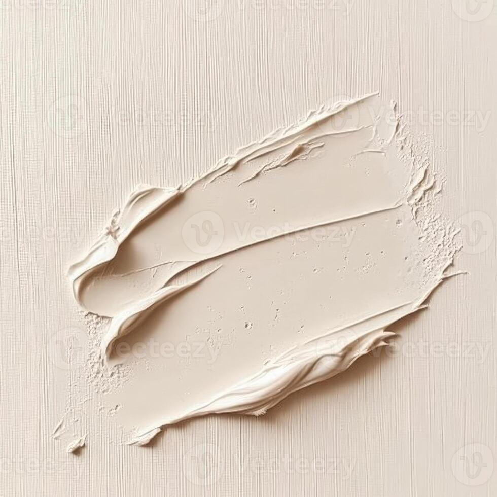 Close-up of a thick, smooth smear of light beige or off-white cream on a textured surface, suggesting skincare product, cosmetic application, or paint stroke photo