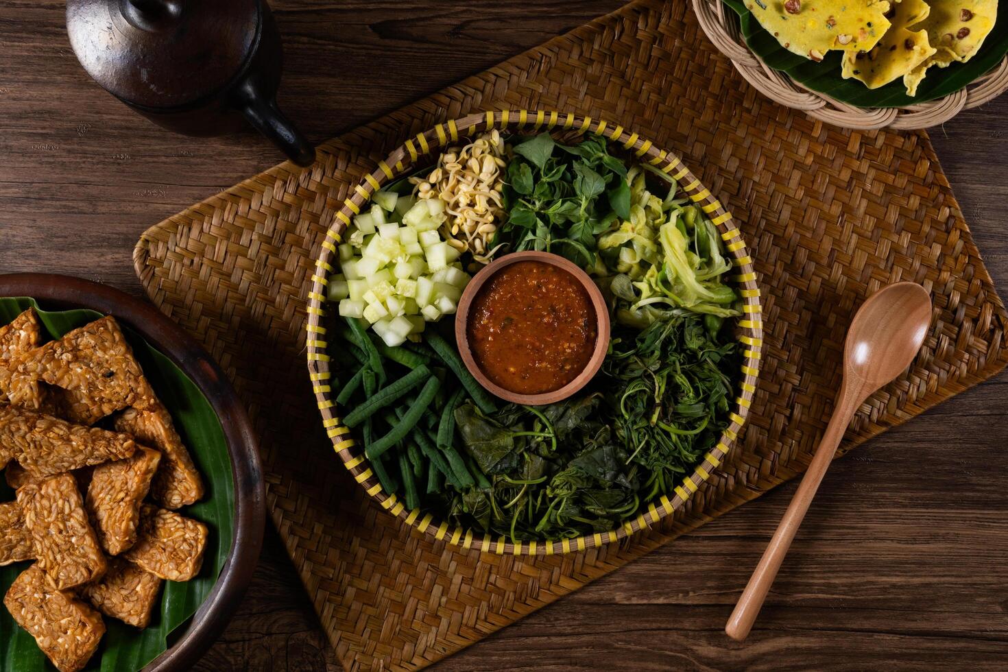 Traditional Indonesian Pecel Ingredients on a Rattan Tray Top View photo