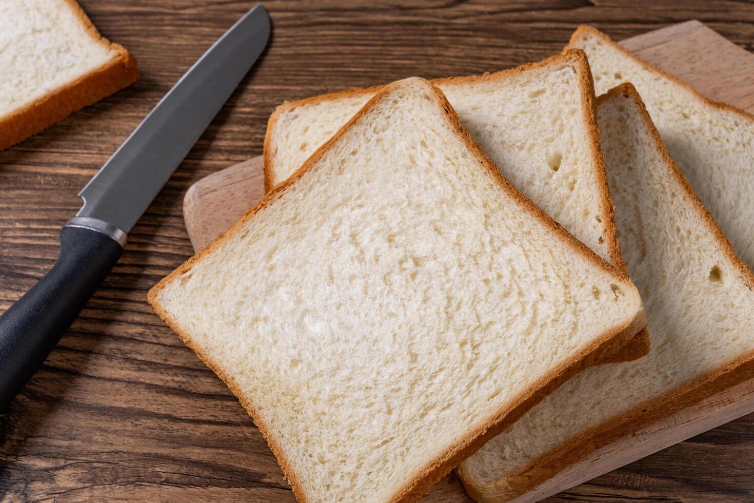 White Bread on Wooden Kitchen Table Isolated Background photo