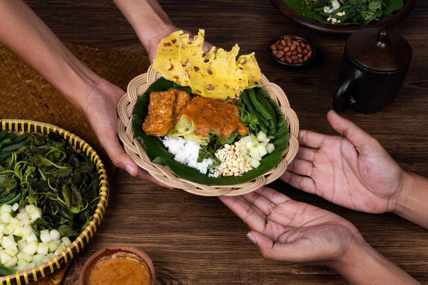 Traditional Street Food Moment Passing Pecel by Hand photo