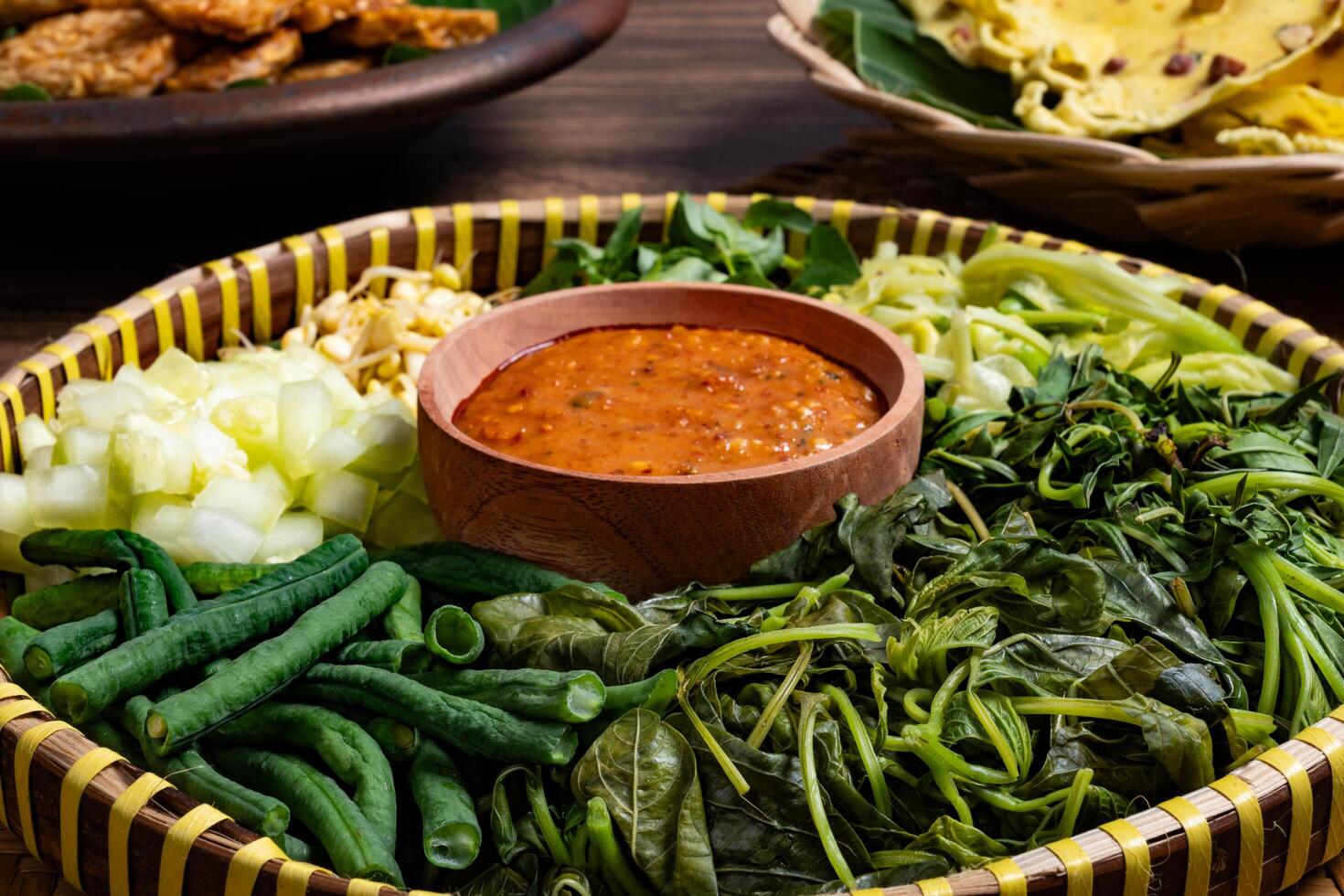 Traditional Indonesian Pecel Ingredients on a Rattan Tray Isolated photo