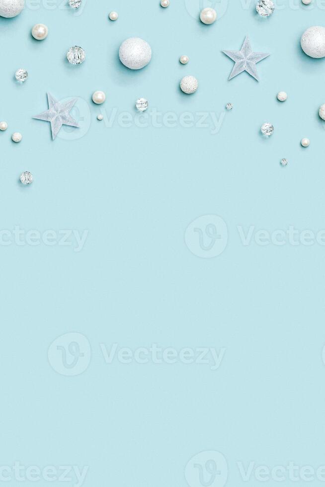 New Year frame with holiday decorations, with winter decoration, white and transparent stars, ball, beads photo