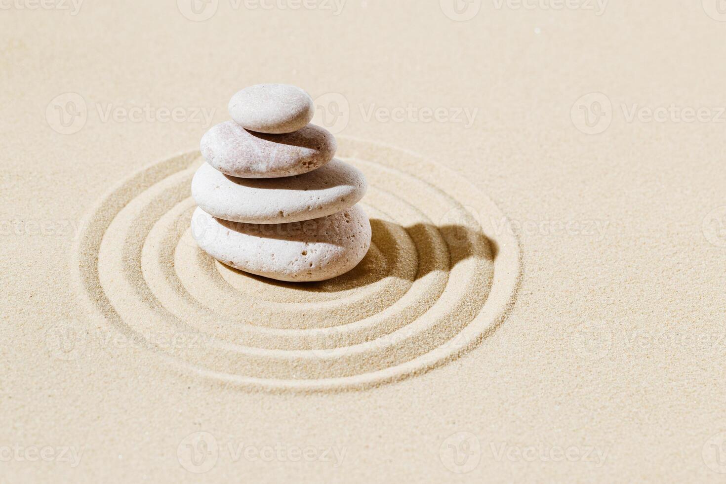 Zen garden meditation sandy background with stone cairn and lines on sand. Relaxation balance and harmon photo