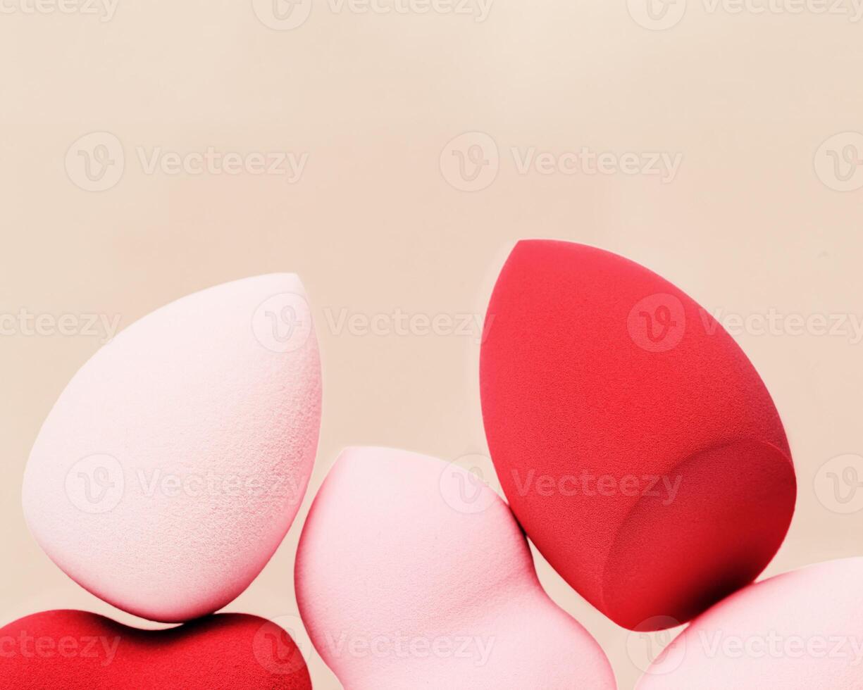 Red and pink cosmetic beauty sponges close up Makeup puff Top view photo