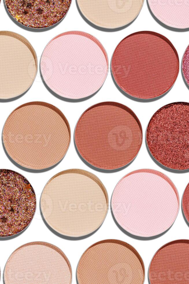 Colorful Swatches eyeshadow refills as minimal geometric pattern. Matte and glitter pans red brown pink shade with sun shadows, detail texture, cosmetic, beauty product, makeup, warm color scheme photo