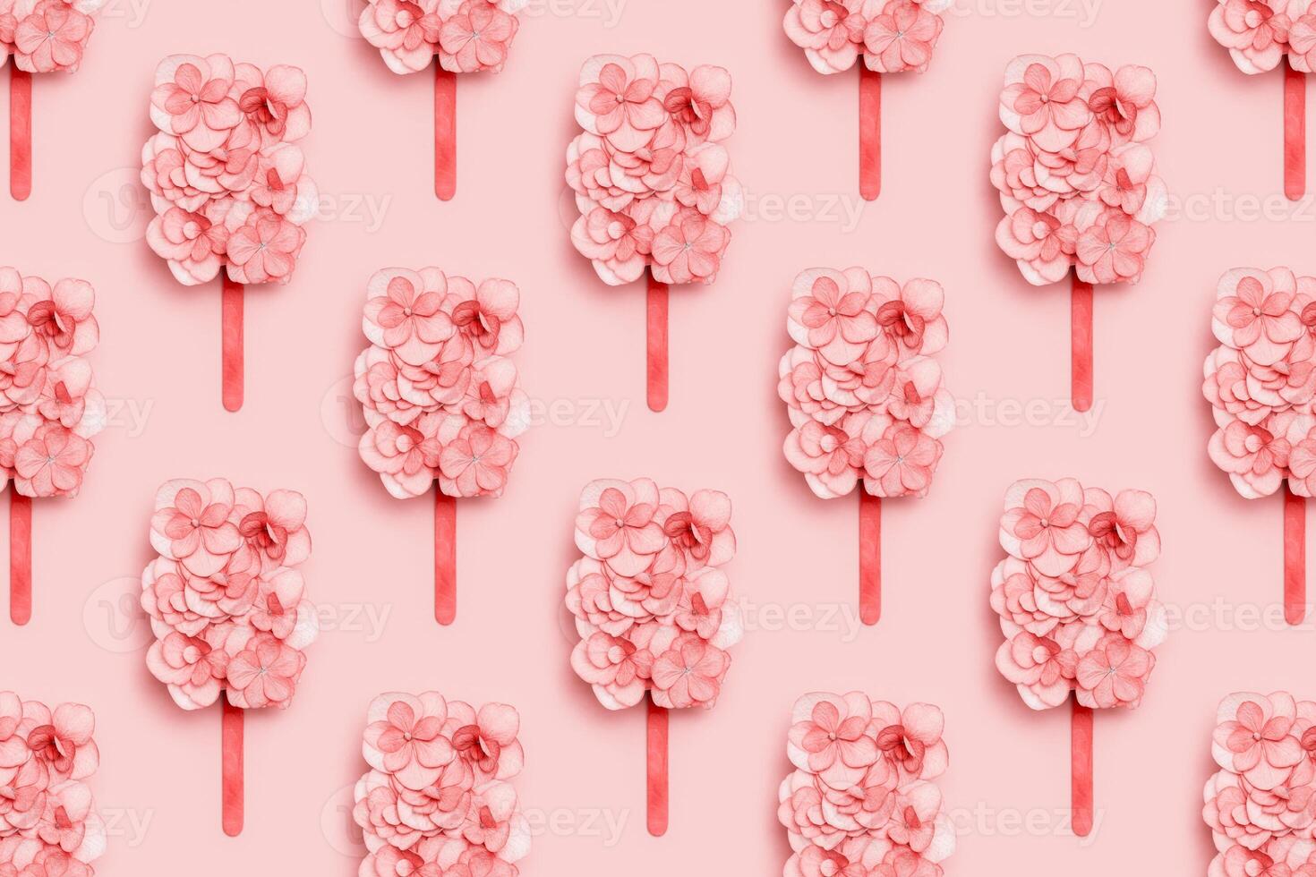 Pattern wuth pink flowers of hydrangea as ice cream on stick or popsicle . Creative concept of summer food photo