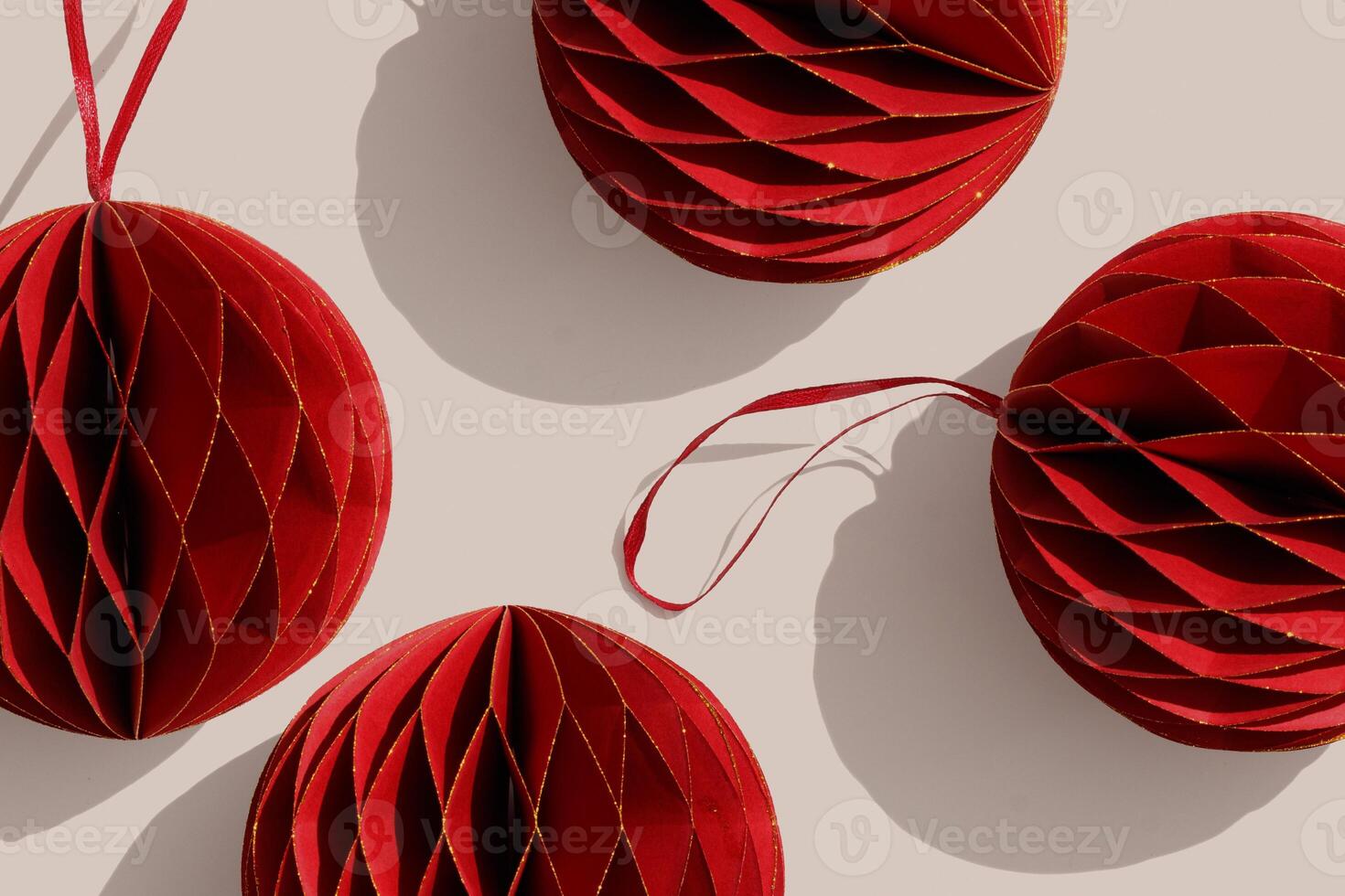 Cut paper Red Christmas ornaments, minimal trend winter holiday graphic pattern, New year red golden shiny balls on beige with shadows, Christmas paper habdmade decorations, top view xmas baubles photo