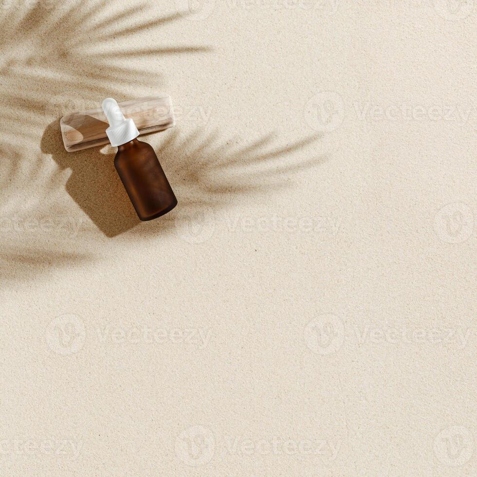 Anti aging serum with collagen and peptides in dark glass bottle with dropper on sandy background with sunlight and shadow photo