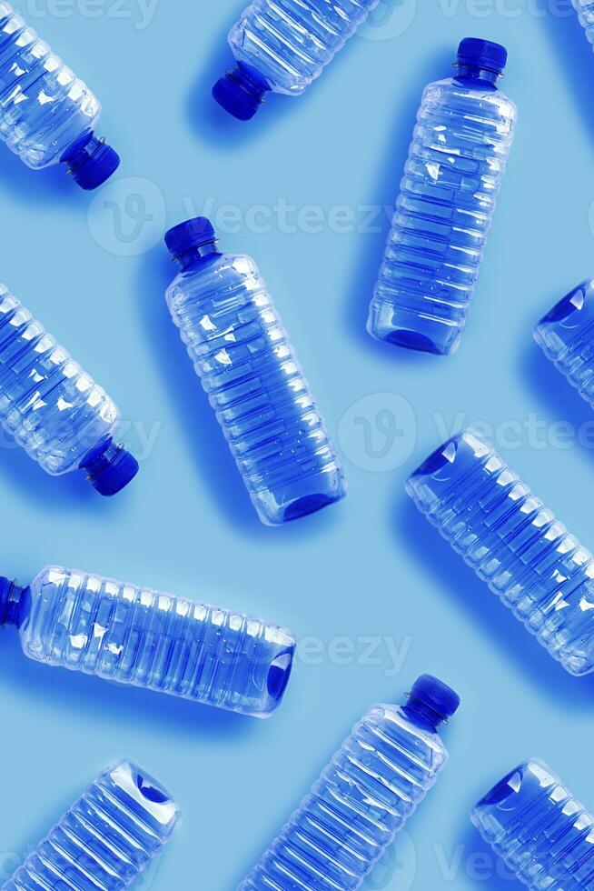 Pattern from Clear plastic water bottles with blue cap on light blue background with soft shadows, Minimal top view, themes of ecology, recycling, sustainable living, reduce disposable plastics photo