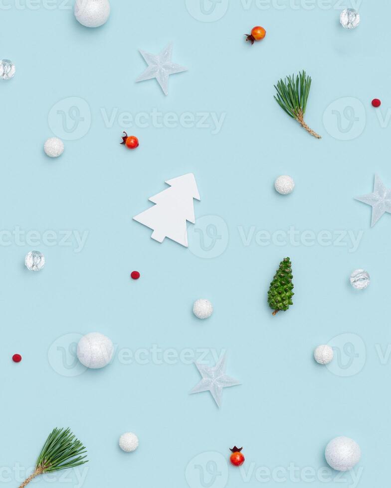 New Year layout with small holiday decorations, branches pine, green cone, red berries, stars, christmas tree photo