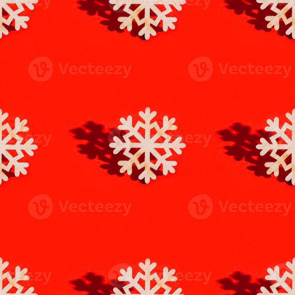 Christmas seamless pattern with wooden snowflakes on red. New Year holiday concept. photo