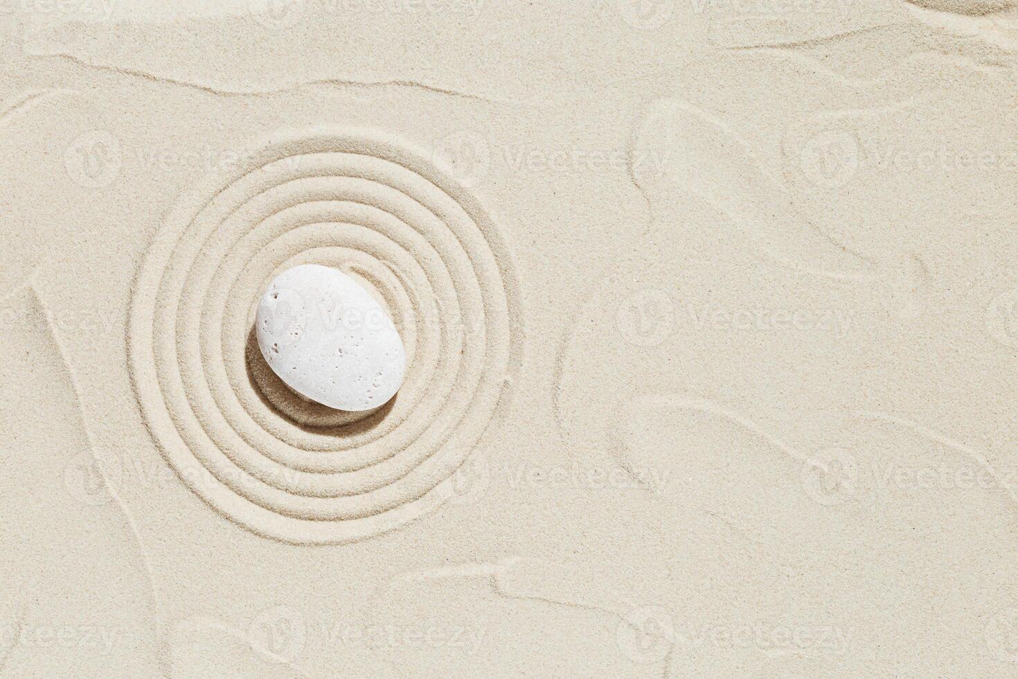 Aesthetic minimal background with zen stone on sand. Pattern in Japanese Zen Garden photo