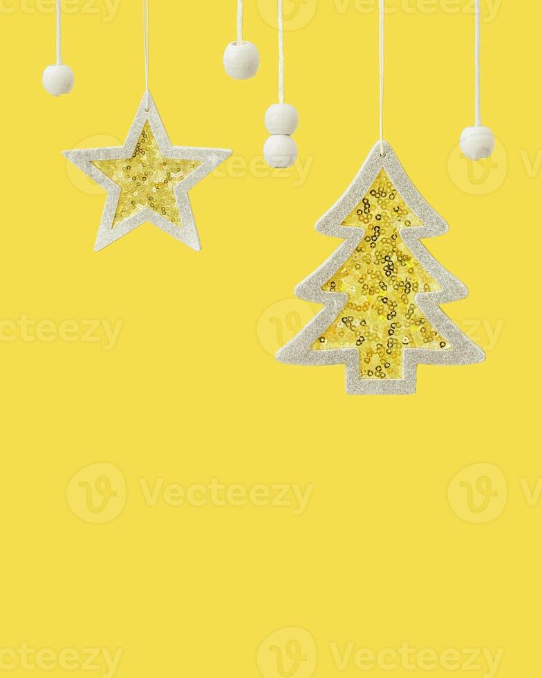 Hanging yellow star and Christmas tree toys with silver sparkling sequins, winter celebration concept, trend color 2021. photo