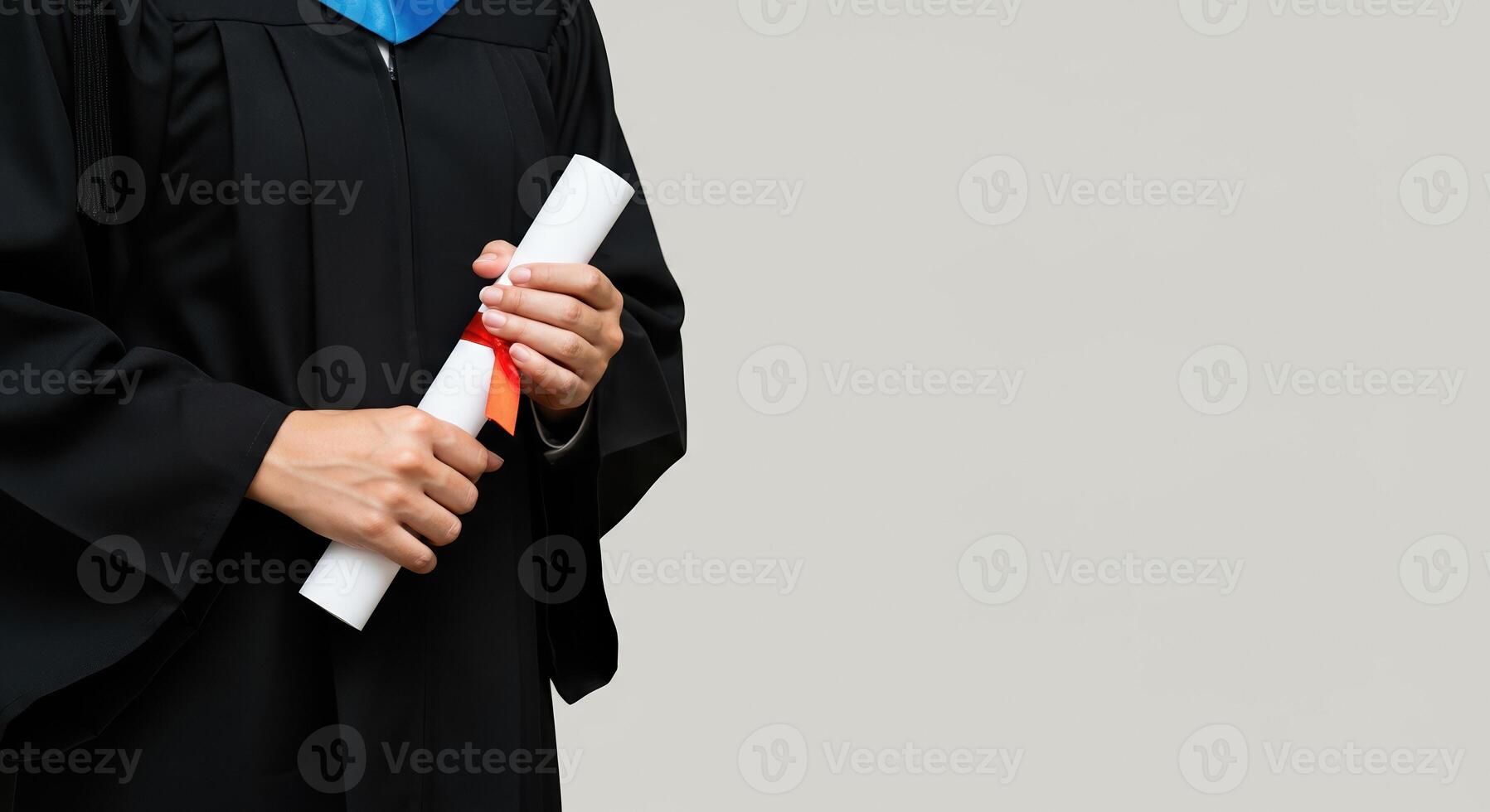 Graduate in gown proudly holds diploma scroll, success symbol. Earned diploma photo