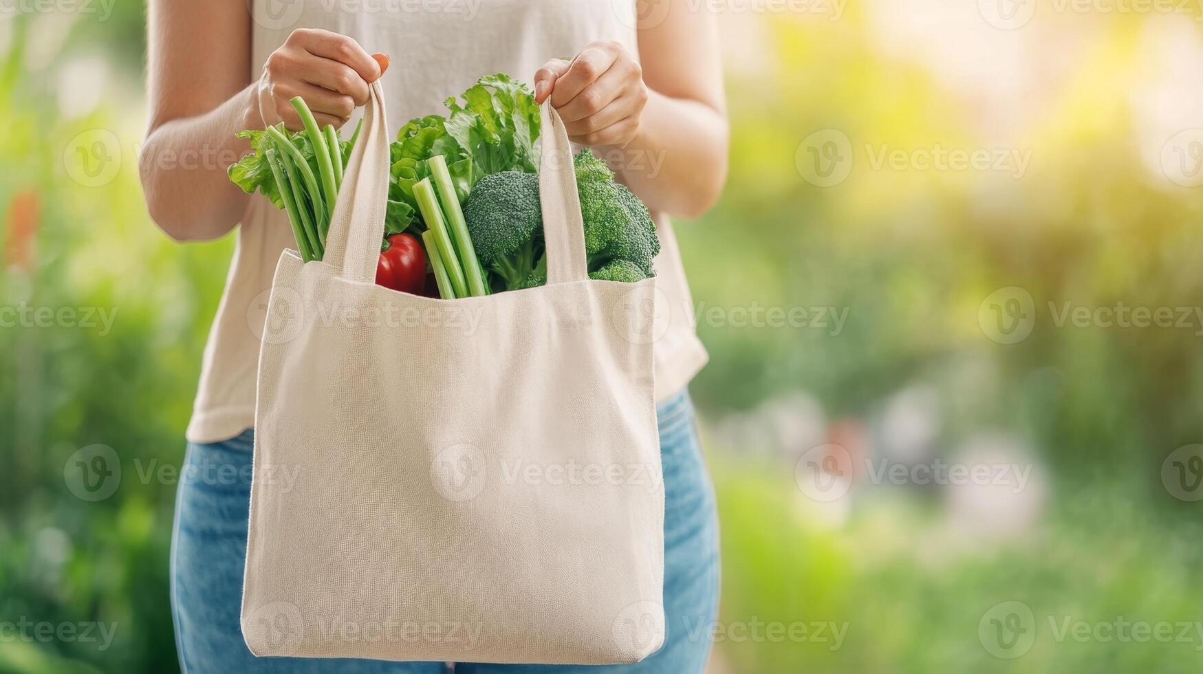 A woman enjoys a sustainable lifestyle, rejecting plastic by using a reusable fabric bag photo
