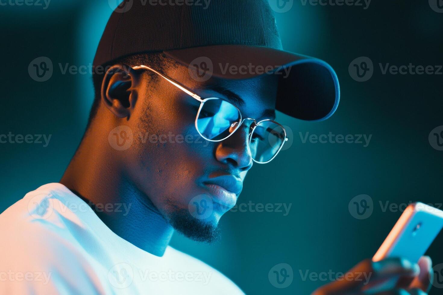 Person interacts with a mobile device, face illuminated by a calming blue light in a dark environment photo