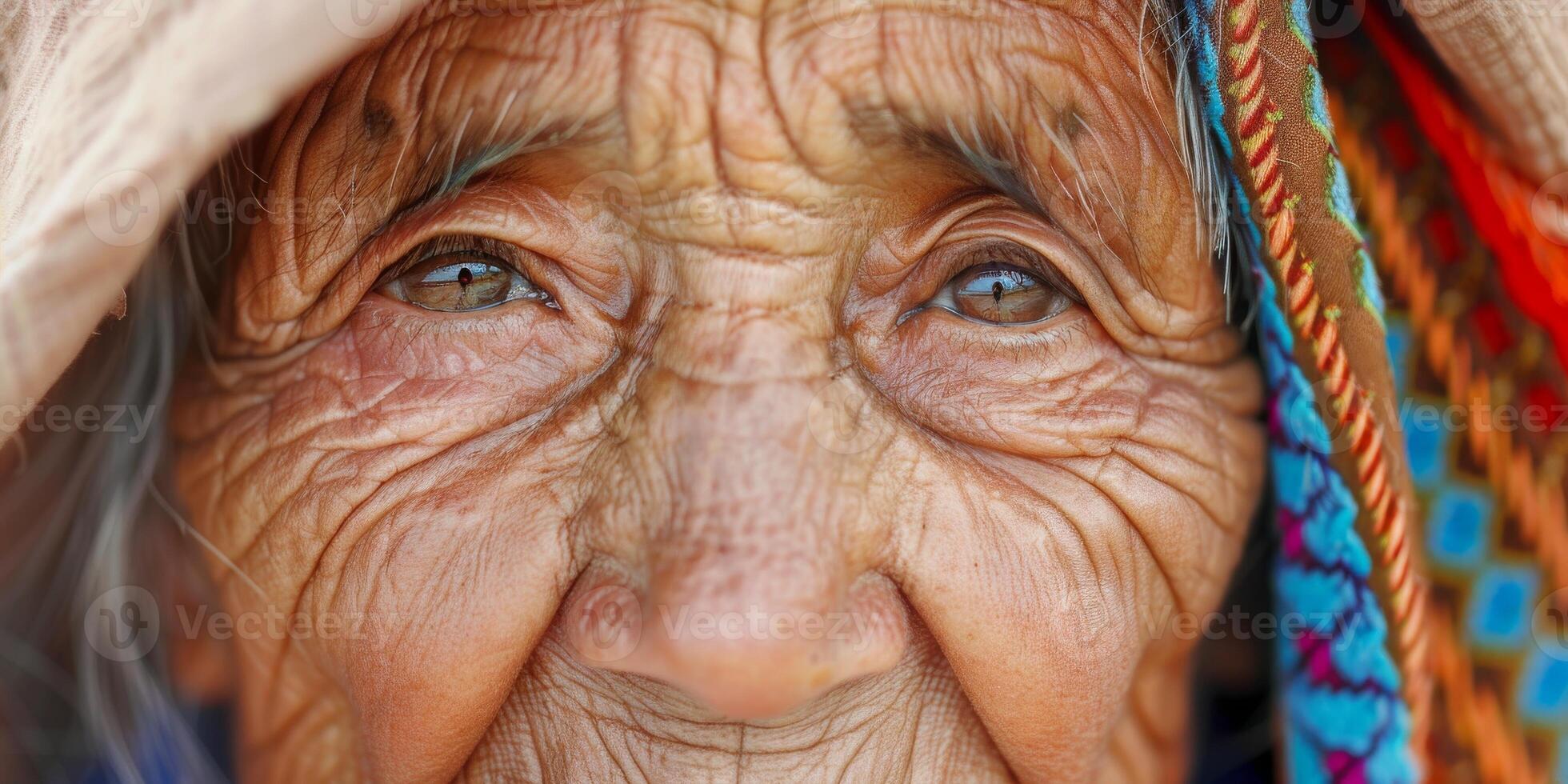 Portrait of an elderly indigenous woman wearing a wearing a colorful patterned scarf photo