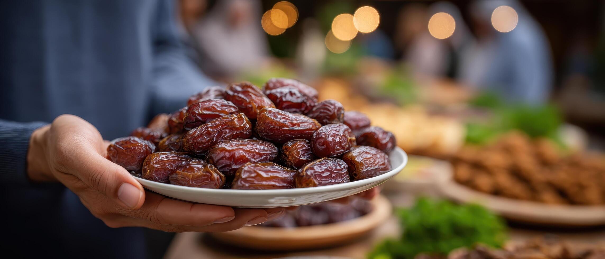 Breaking fast together friends share dates at a festive gathering in a cozy outdoor setting photo