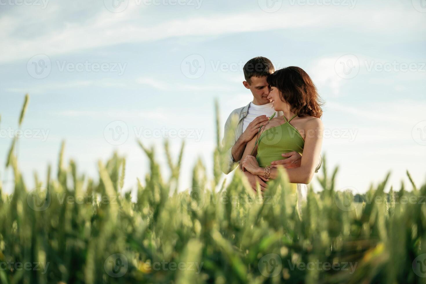 Standing,and enjoying nature and each ,,other. Lovely couple are on the agricultural field together photo