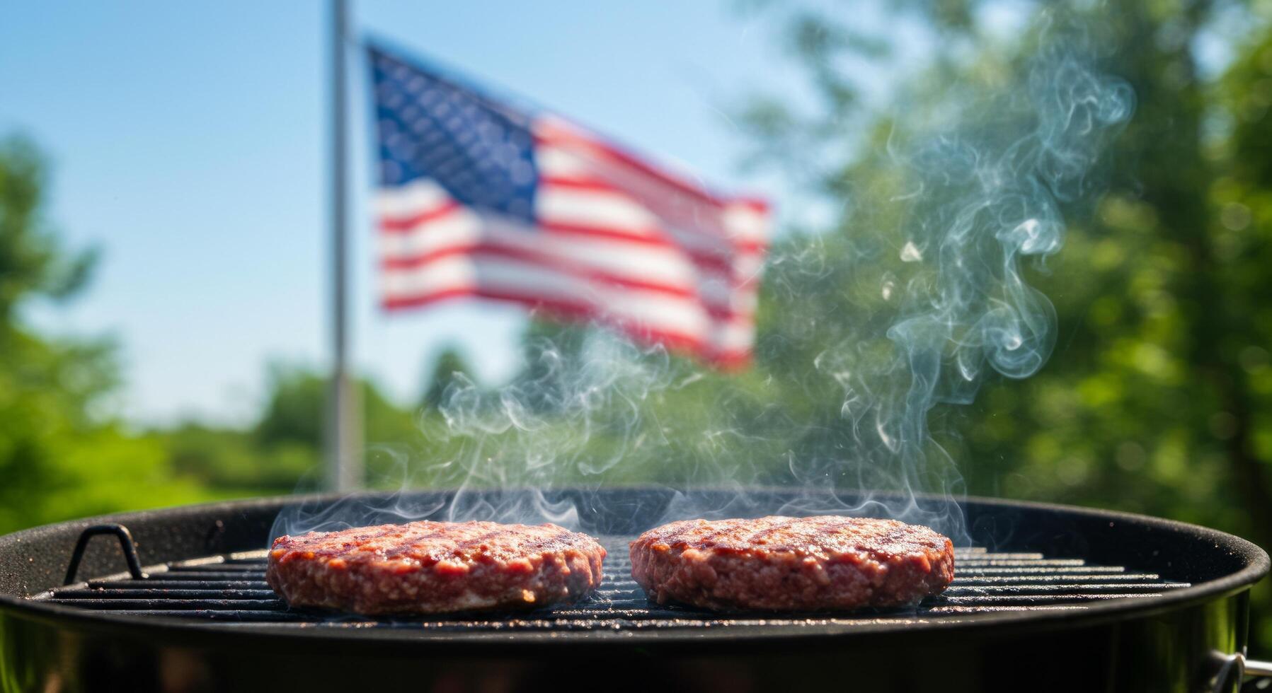 Grilling Burgers on a Sunny Day with the American Flag in the Background photo