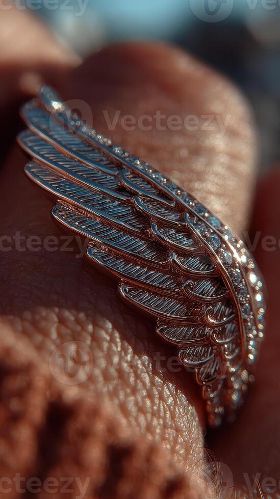 Intricate silver wing ring captures sunlight in a close-up display during a sunny afternoon photo