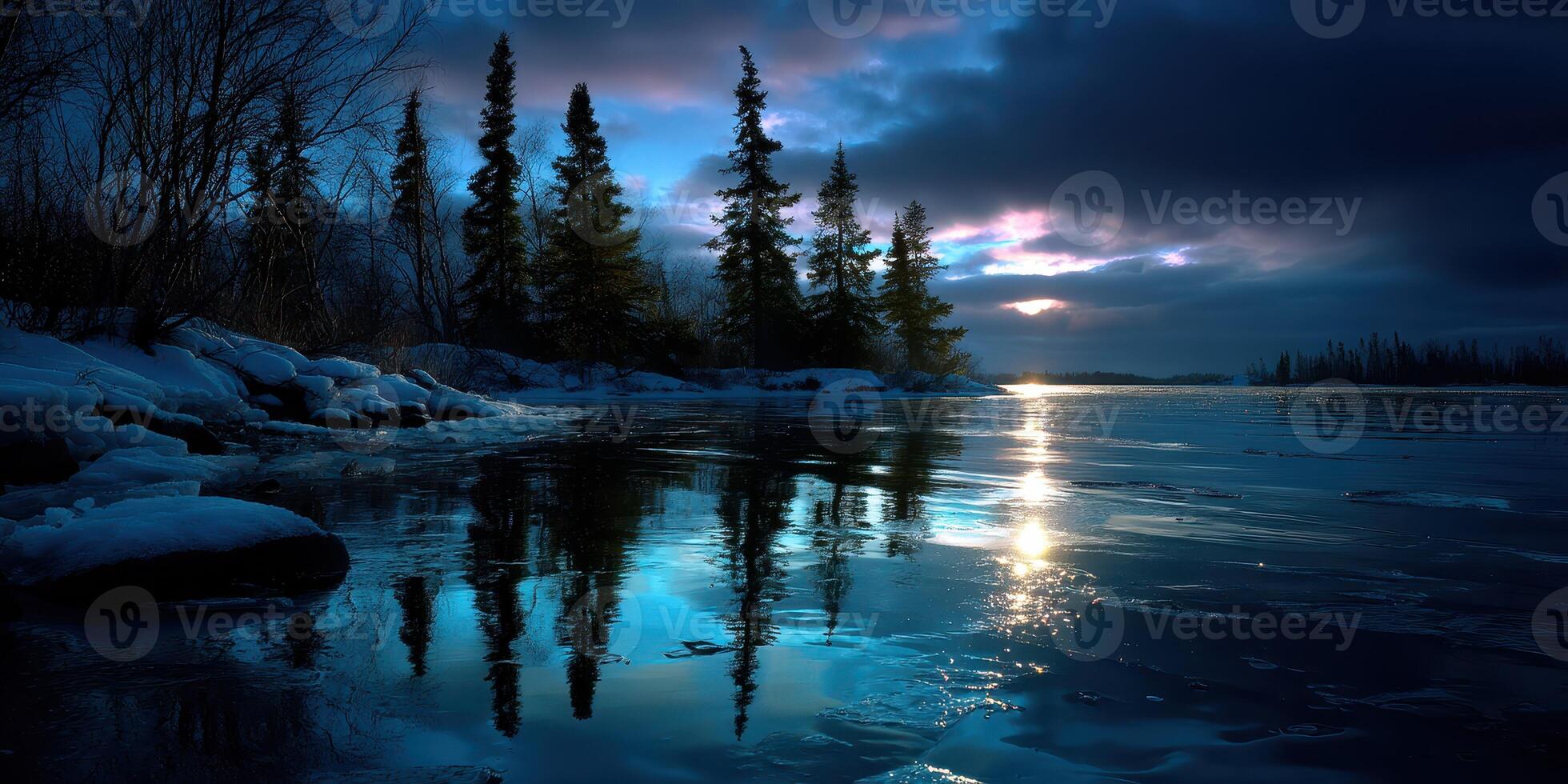 Twilight reflections over a serene lake with evergreen trees under a cloudy sky photo
