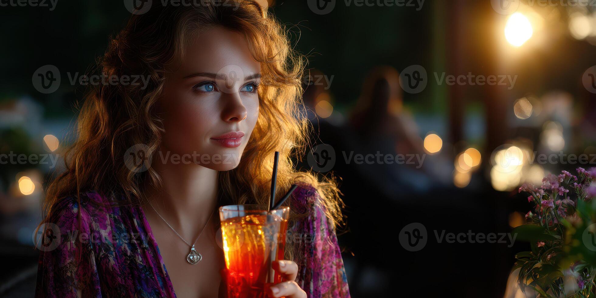 Evening gathering at a garden party with a woman enjoying a refreshing drink surrounded by soft lights photo