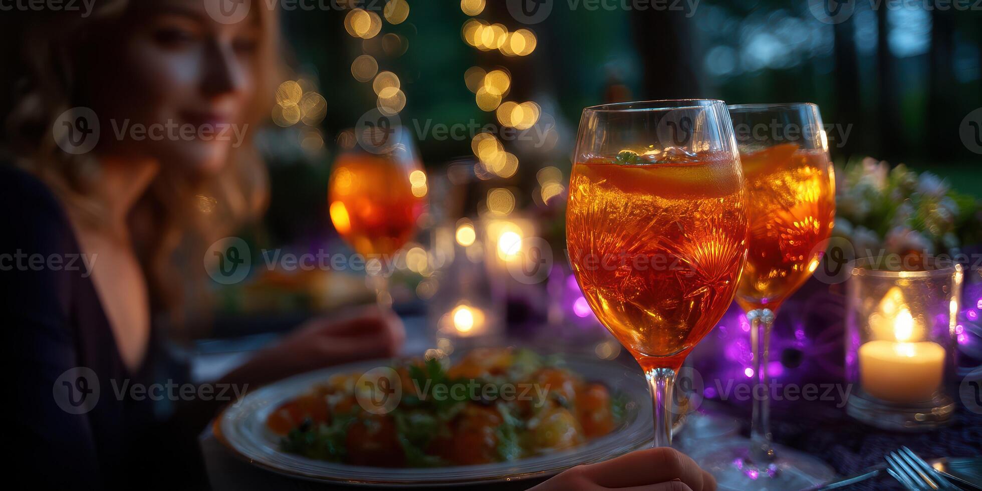 Enjoying a vibrant outdoor dinner party with sparkling drinks and twinkling lights at twilight photo