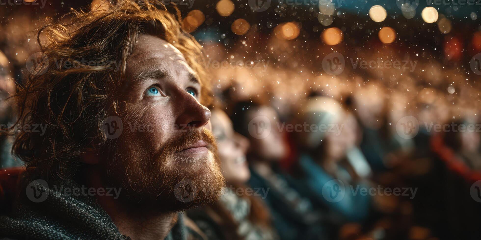 Audience member captivated by performance in a theater setting during evening show photo