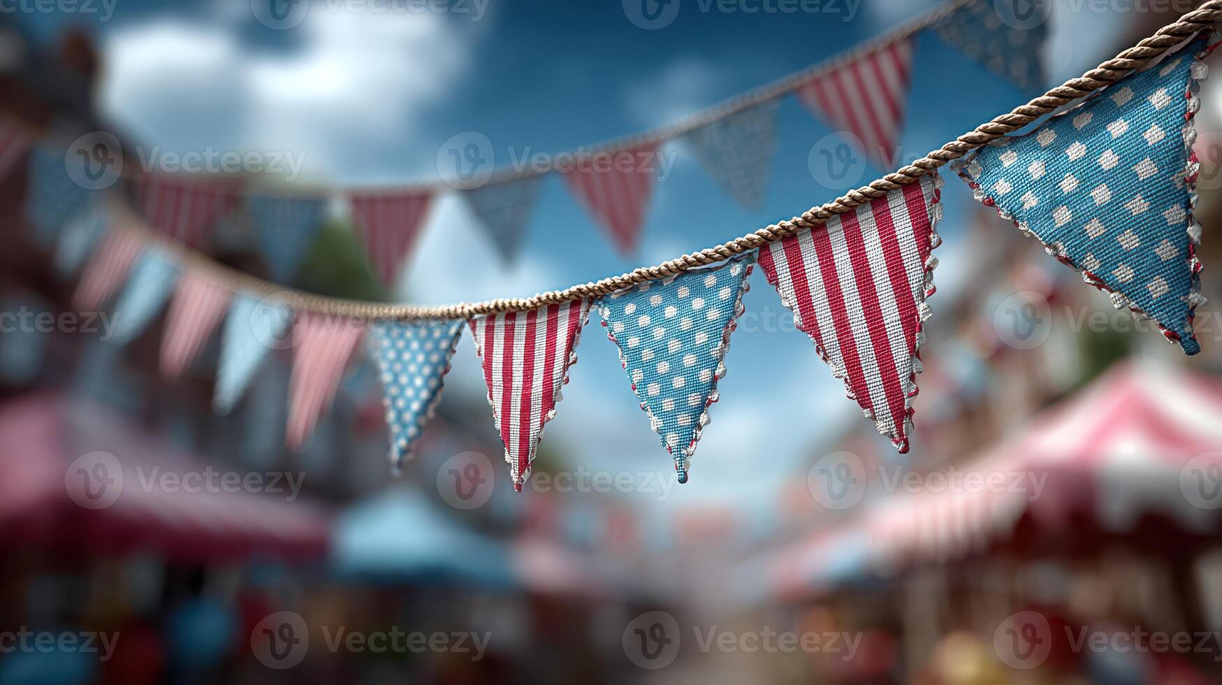 Colorful bunting decorates a festive street market filled with vendors and cheerful visitors during a sunny afternoon photo