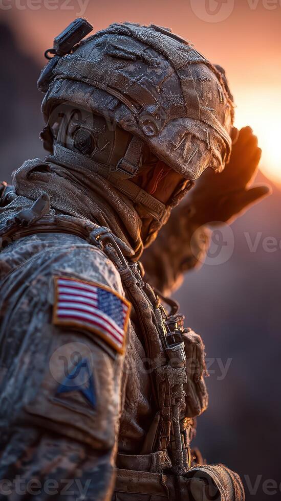 Soldier salutes the setting sun amidst a rugged landscape during twilight hours photo