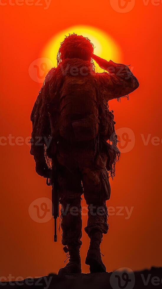 Soldier salutes against the backdrop of a dramatic sunset in a training exercise photo