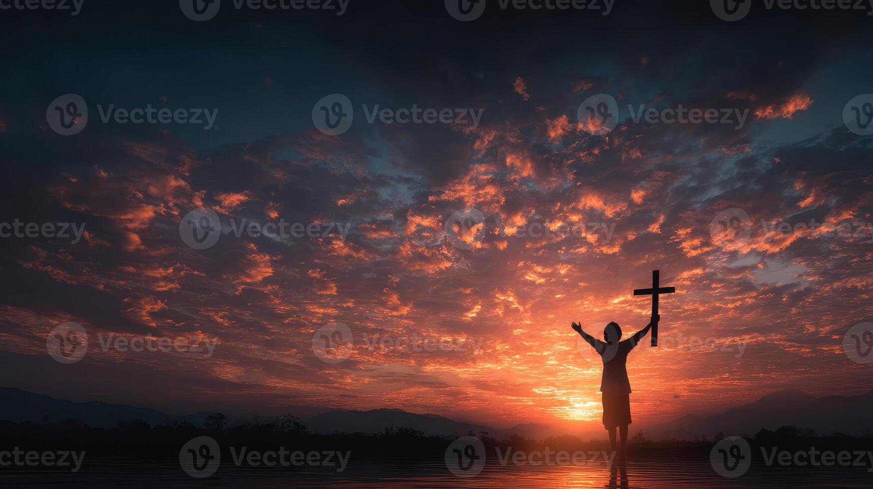Silhouetted figure holds cross during stunning sunset over tranquil waters in serene landscape photo