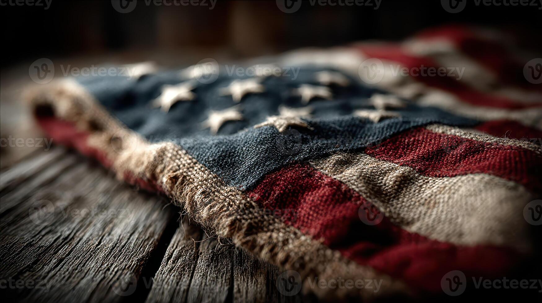 Worn fabric American flag resting on rustic wooden surface, capturing history and patriotism in a quiet moment photo