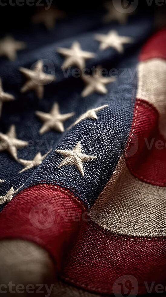 Close-up view of a worn American flag showcasing vibrant colors and detailed stitching against a dark background photo