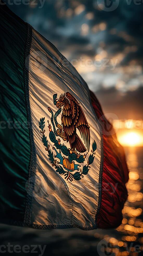 Mexican flag waves at sunset with vibrant colors over the ocean creating a striking visual atmosphere photo
