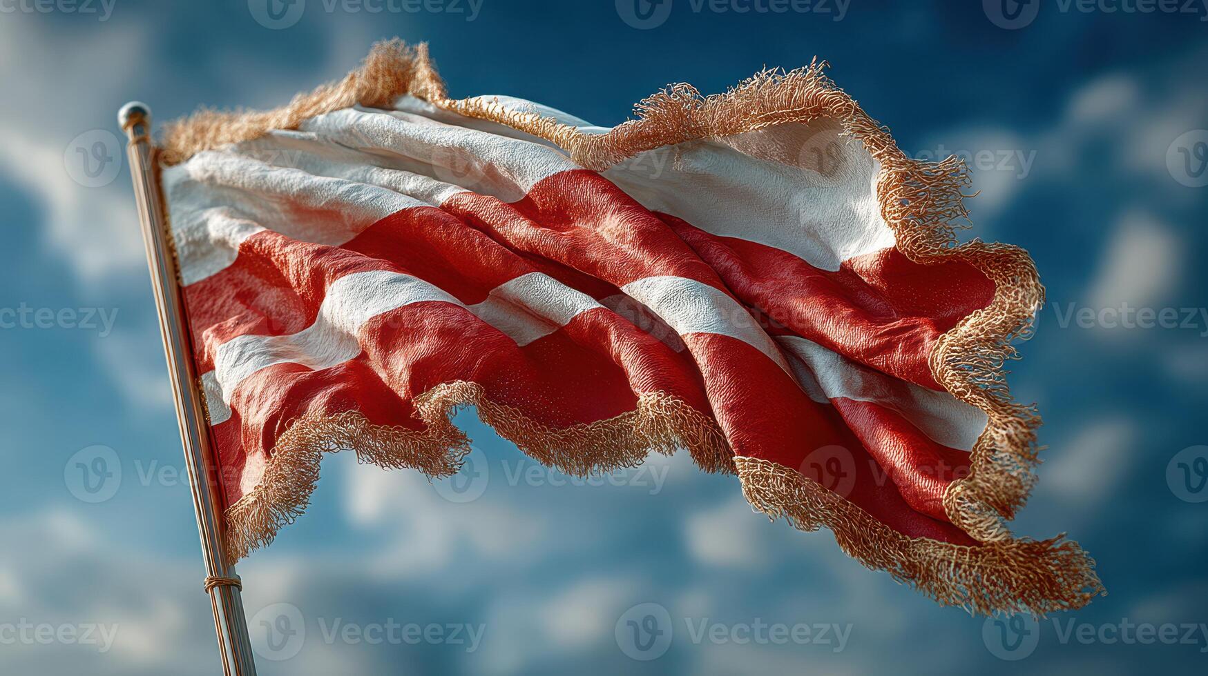 Vibrant red and white striped flag waving against a clear blue sky during a sunny day photo