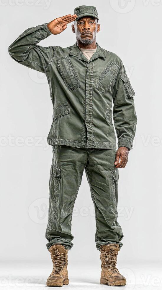 Man in military uniform salutes while standing in a neutral background during daylight hours photo