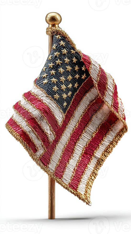 Handcrafted miniature American flag displayed on a golden pole in a symbolic representation of patriotism and national pride photo