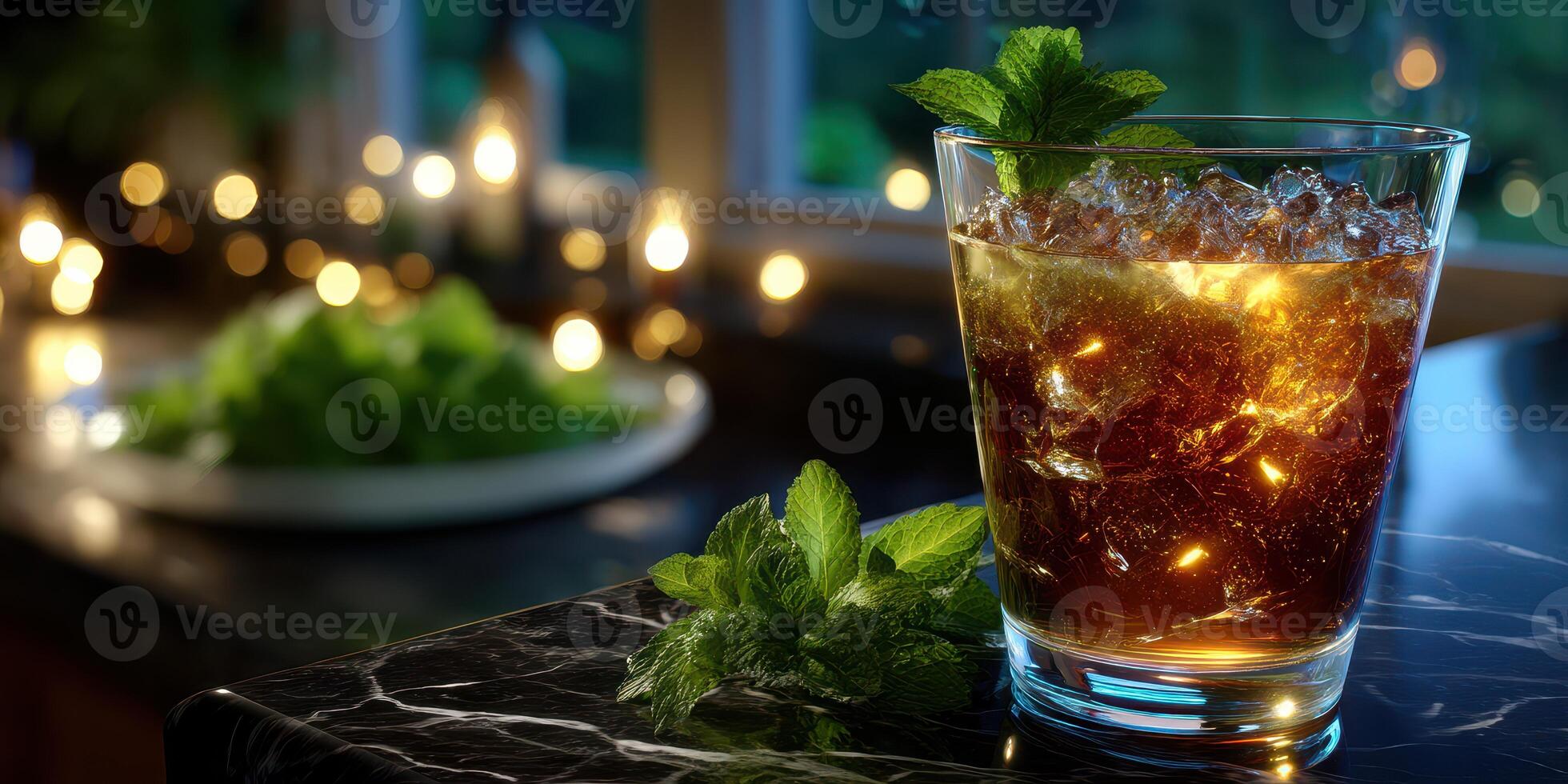 Refreshing drink with mint served on a marble countertop during evening gathering photo