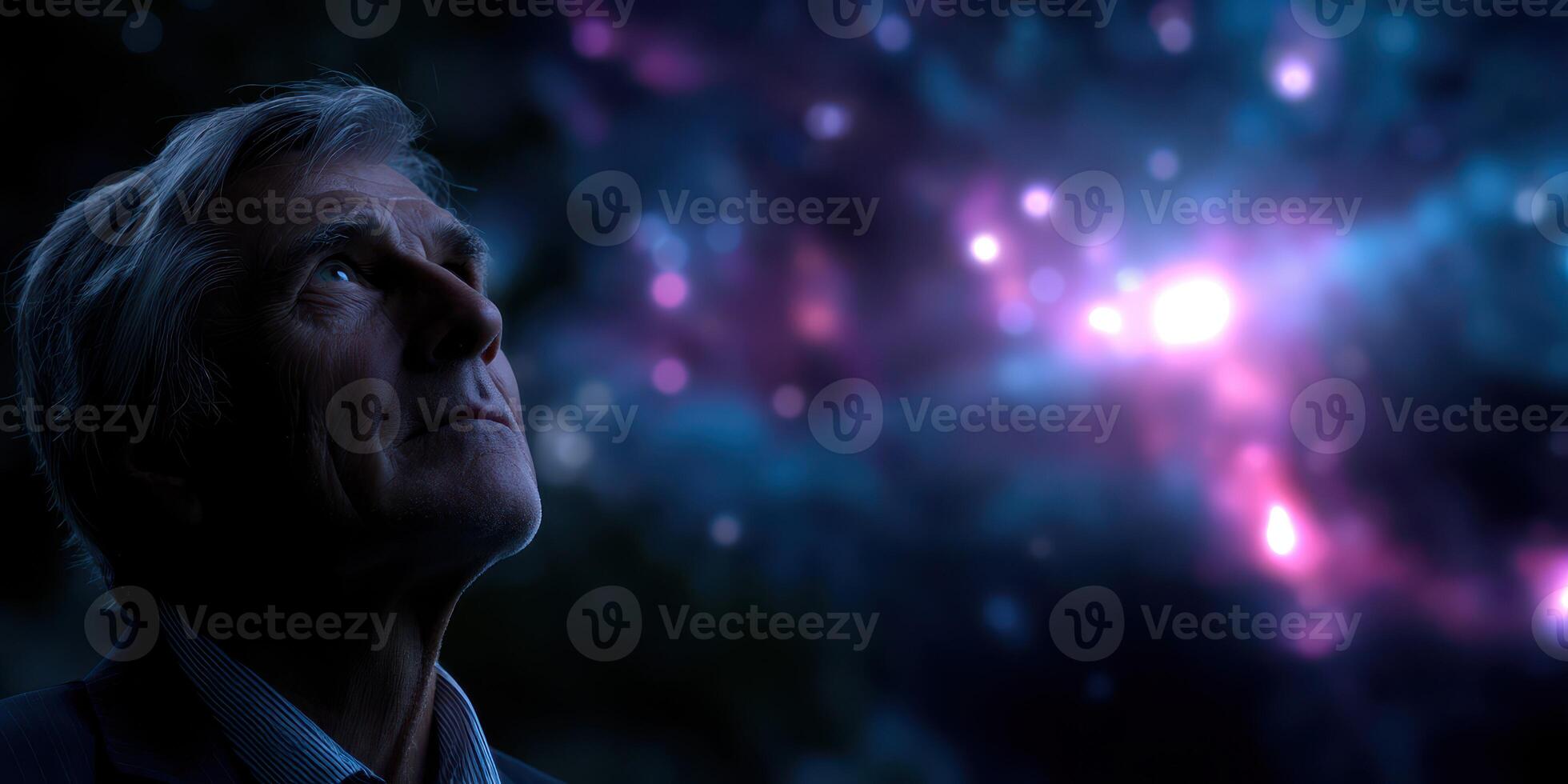 Elderly man gazes at a starlit sky filled with cosmic colors during a serene nighttime moment photo