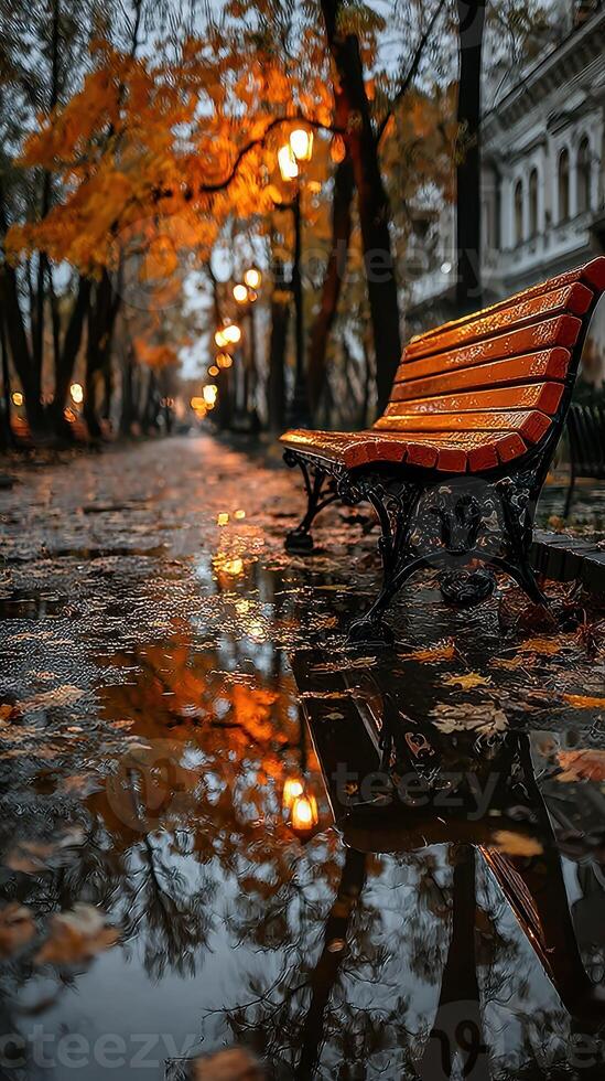 Autumn evening in the park with reflections and warm street lights illuminating the wet path photo