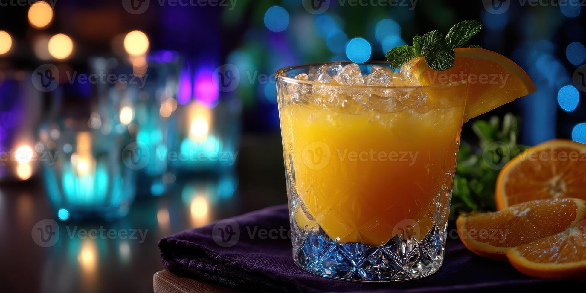 Refreshing orange cocktail garnished with mint and orange slices at a cozy evening setting filled with soft lighting photo