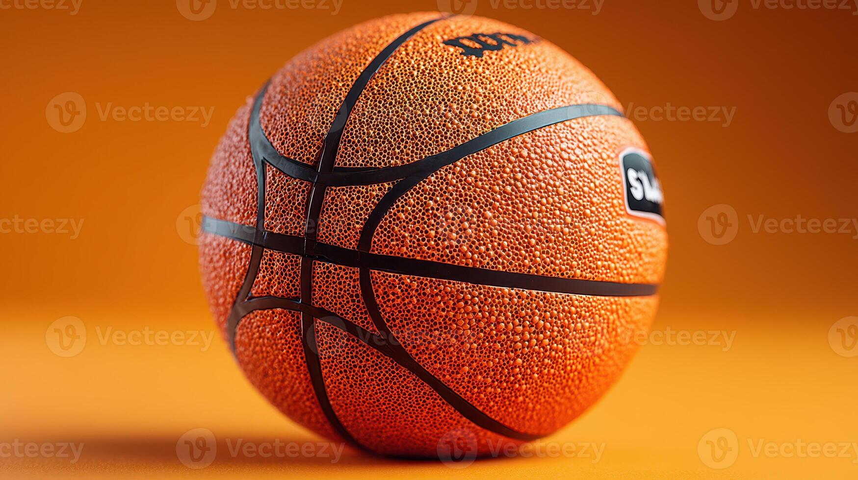 Basketball resting on a smooth orange background showcasing its texture and details in close-up view photo